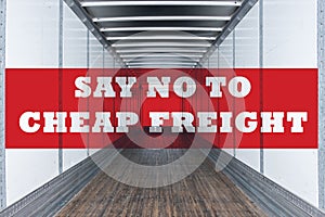 Say no to cheap freight written on empty commercial semi trailer interior. Concept of american truckers protest due to load rates