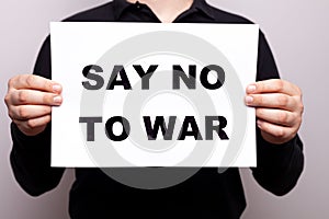 say no to war. No violence. a man holds a poster in his hands with appeals, a message not to use aggression. no war. a