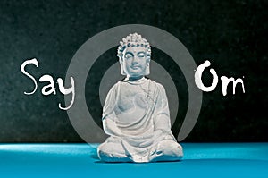 Say Om - Little Buddha statue, meditation, zen and relax yoga concept