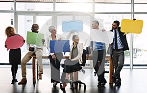 Say it proud. a group of businesspeople holding speech bubbles in an office.