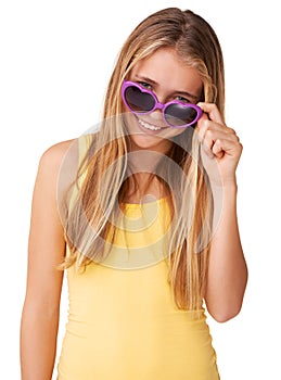 Say what. Portrait of a cute teen girl peering over her heart-shaped glasses.