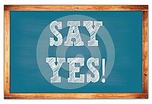 SAY YES! words on blue wooden frame school blackboard