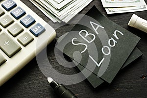 SBA loan handwritten memo on the calculator photo