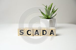 Scada word concept on cubes, network concept.