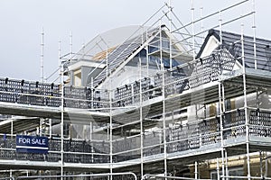 Scaffold at construction of new houses in residential building site