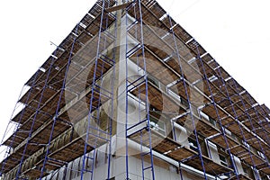 Scaffolding around a high-rise building. Repair work. Renovation of the building