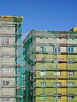 Scaffolding arround the house to install thermal insulation of the apartment building facade