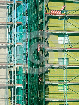 Scaffolding arround the house to install thermal insulation of the apartment building facade