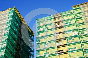 Scaffolding arround the house to install thermal insulation of the apartment building facade