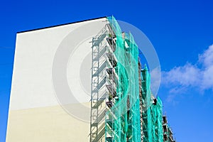Scaffolding arround the house to install thermal insulation of the apartment building facade
