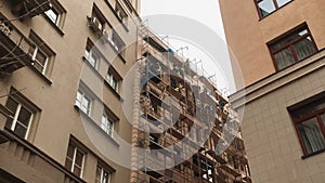 Scaffolding concept repair construction. workers make repairs to the facade of the building. workers make repairs to the
