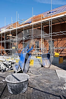 Scaffolding on a construction site of a row of new houses to be built