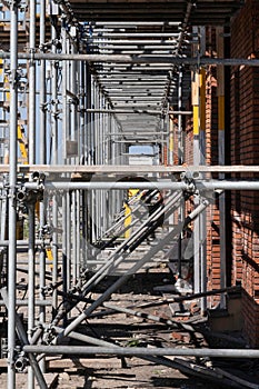 Scaffolding on a construction site of a row of new houses to be built