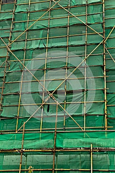 Scaffolding and green netting abstract backgground