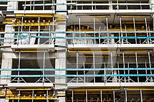 Scaffolding on  house facade, apartment building under construction