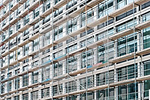 Scaffolding on  house facade, apartment builing under construction