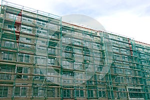 Scaffolding for insulating the facade of a new house. Construction of houses.