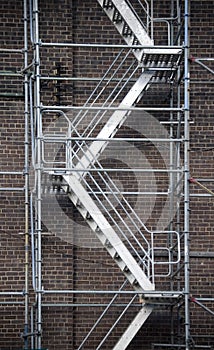 Scaffolding ladder against brick wall