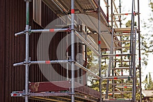 Scaffolding mounted to repaint facade of houses in Roback