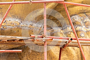 Scaffolding for rebuild or repair ancient Buddha statue in construction site,scaffold for construction