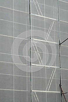 Scaffolding. Scaffold covered with a white canvas for protection