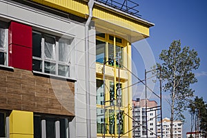 Scaffolding and scaffolding with wooden decks, against a blue sky. Performing construction work at height. Construction safety