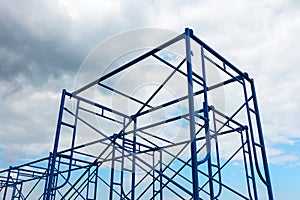 Scaffolding site erection on cloudy background.