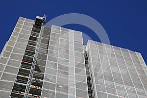 scaffolding of a skyscraper during maintenance to install the thermal insulation  seen from below photo