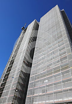 Scaffolding of a skyscraper during maintenance works for the installation of polyurethane panels to thermal insulation photo