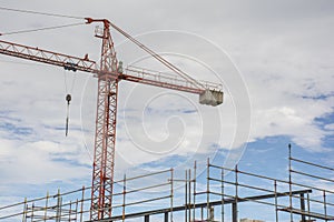 Scaffolding structure and a crane at a construction site
