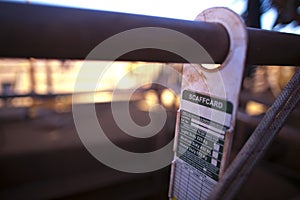 Scaffolding tag label safety warning sign displaying hanging on the scaffold tube at construction mine site