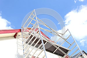 Scaffolding tower worker rooftop painting house, Netherlands photo