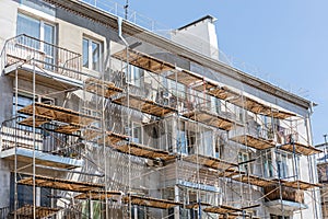 scaffolding on urban apartment building. facade renovation of old house.