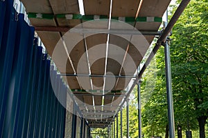 a scaffolding and wooden planks for protection and coverage on a construction site