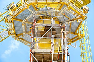 Scaffolding work on offshore oil and gas central processing platform while erected to crane column for repair structure of crane.