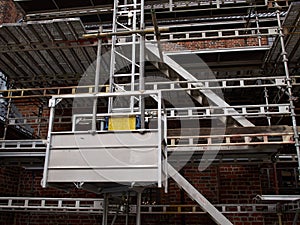 Scaffolds on a house building under renovations photo