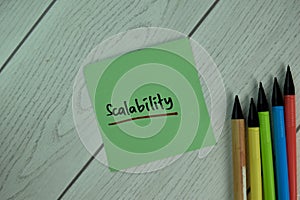 Scalability write on sticky notes isolated on Wooden Table