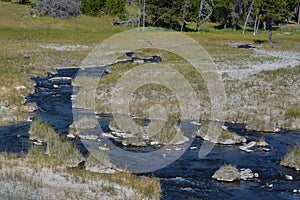 Scalding water flowing in a thermal desert at Upper Geyser Basin in Yellowstone National Park, Wyoming photo