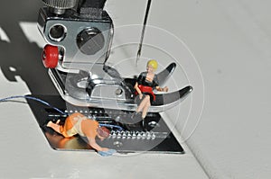 Scale H0 diorama:housewive cleans a sewing foot of an electric sewing machine photo