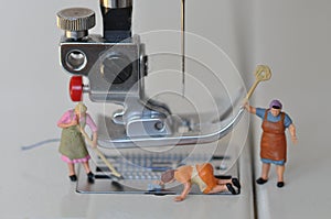 Scale H0 diorama :three housewives clean a sewing foot of an electric sewing machine photo