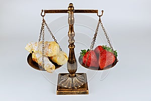 Scale with healthy and unhealthy food on white background