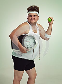 Scale, man and portrait with apple for health, fitness or nutrition isolated on gray studio background mockup. Plus size