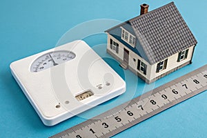 Scale model of a house on blue background