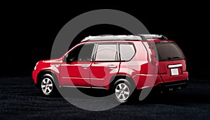 Scale model of a red car on a black background