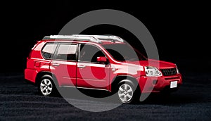 Scale model of a red car on a black background