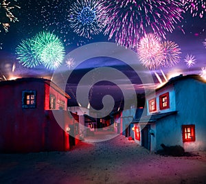 Scale model of a typical mexican village at night with fireworks