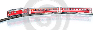 Scale toy model of red train isolated on white reflective background