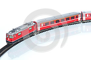 Scale toy model of red train isolated on white reflective background