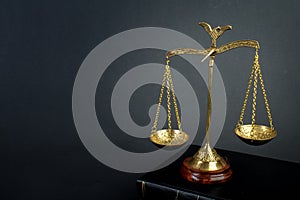 Scales and books on jurisprudence on a wooden background. Legal and law concept