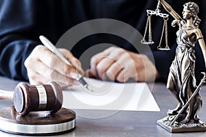 Scales of justice with judge gavel on table